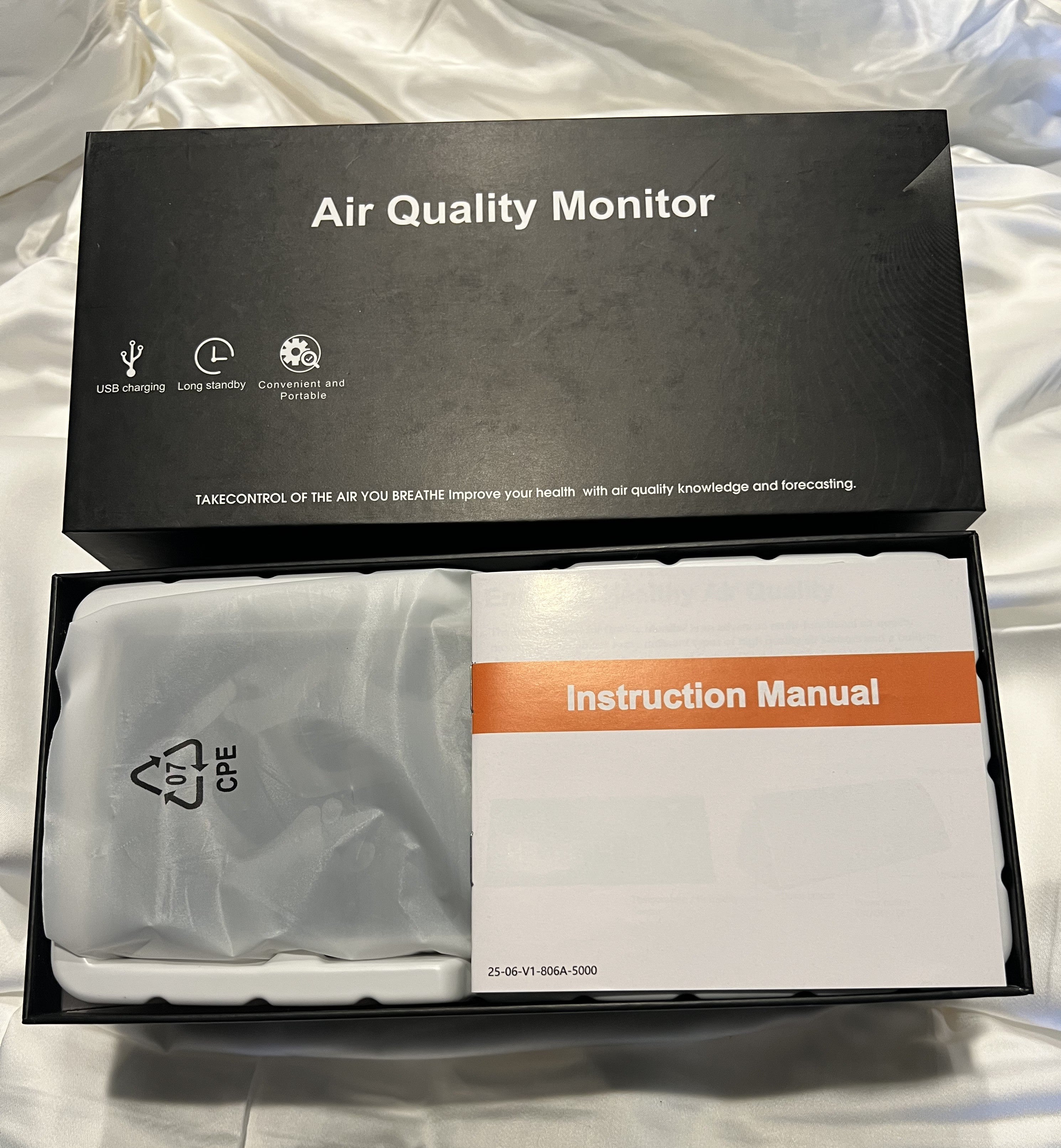 Instruction manual for the Digital 9 in 1 air quality monitor with various readings on a white background. pm 2.5, CO2, and Radon Monitoring. USB Cable on black box. Monitor your IAQA at home or in the workplace with this portable device.