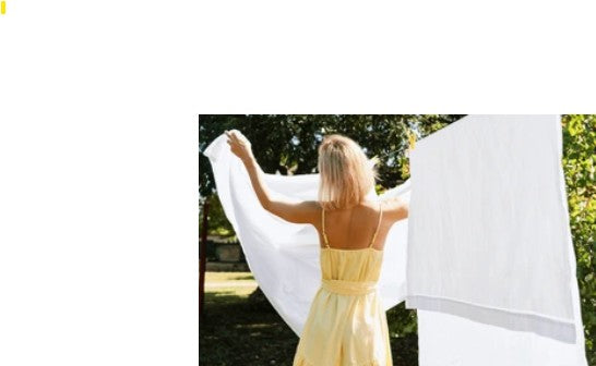 A person standing in an outdoor setting with a white, lightweight sheet draped over their shoulders, suggesting the softness and elegance of the product.
well build connection