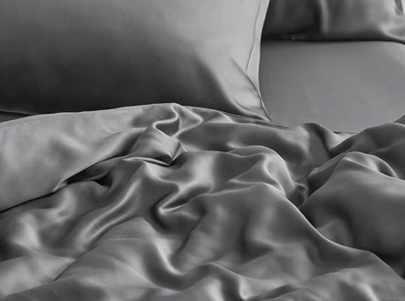 Organic Viscose Bamboo Bedding Sheets Set displayed on a bed, showcasing the fitted sheet, flat sheet, and pillowcases. The sheets are beige, and the image includes icons indicating various product features such as being eco-friendly, breathable, and soft. Well Building Connection Luxurious Bed Sheets