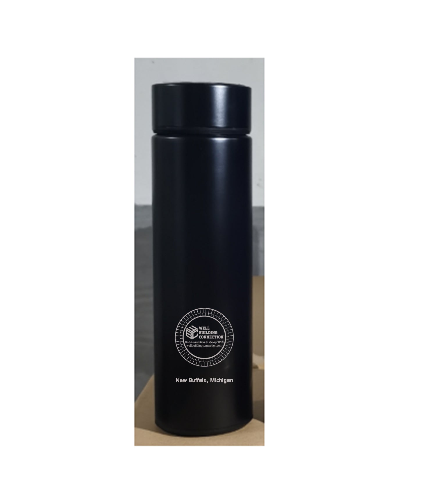 A black insulated stainless steel water bottle with an LED temperature display and a white circular Well Building Connection logo on the front.