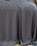 Organic Viscose Bamboo Bedding Sheets Set displayed on a bed, showcasing the fitted sheet, flat sheet, and pillowcases. The sheets are beige, and the image includes icons indicating various product features such as being eco-friendly, breathable, and soft. Well Building Connection Luxurious Bed Sheets