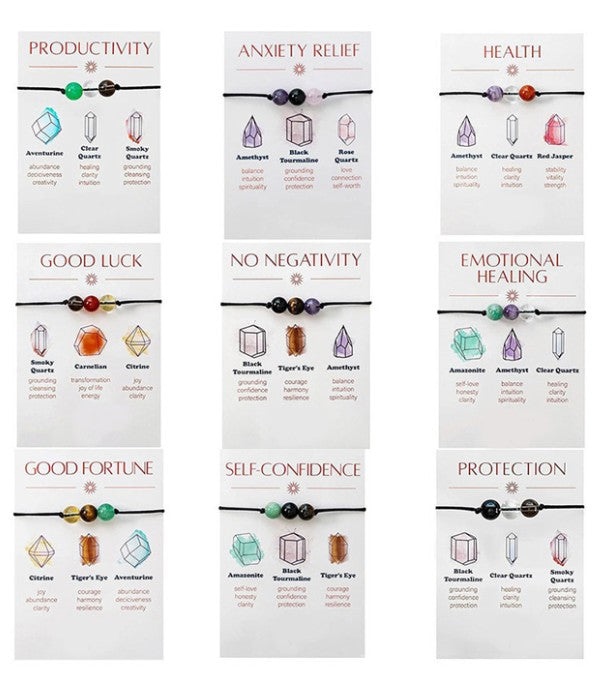 Set of crystal bracelets with corresponding benefits on white cards. Self-Care and Well-being: Gifting yourself or wearing intentional jewelry can enhance your mood, increase feelings of joy, and contribute to overall emotional well-being.