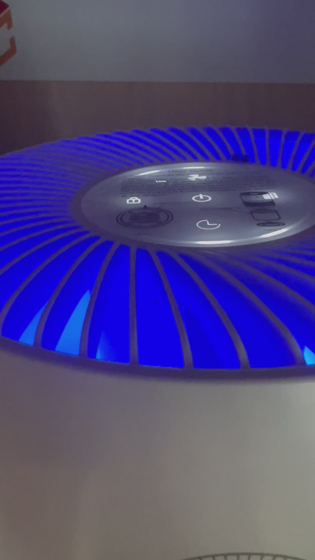 Blue on the hepa air purifer means that it is cleaning the air. A white cylindrical HEPA air purifier with a perforated lower section and a Well Building Connection logo on the front. Indoor Air Pollutants too many to list and everyone benefits from this air purifier from Well Building Connection.