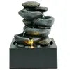 A compact desktop water fountain featuring a stack of rocks with water flowing over them, set on a black base. Transform your home or workplace into a peaceful oasis with the Well Desktop and Tabletop Water Fountains. Designed to enhance natural and sustainable décor, these elegant fountains bring the soothing sights and sounds of flowing water into any setting, promoting relaxation, balance, and mindfulness from Well Building Connection.
